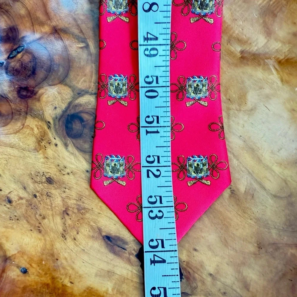 Vintage Hermès red silk tie with a repeating drum motif 3.5” x 54”